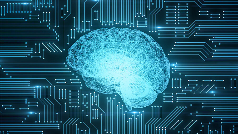 Leiterplatte eines Computers als Hintergrund auf der mittig im Vordergrund ein stilisiertes Gehirn zu sehen ist.